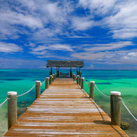 The beautiful blue/green waters of the Bahamas accessed down a wooden pier