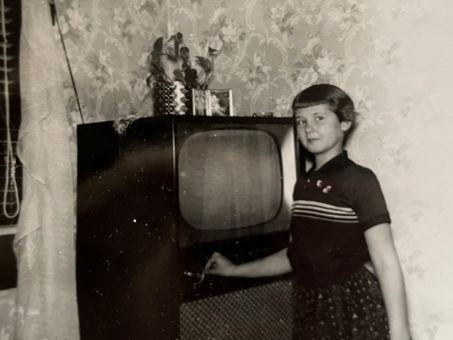 Girl standing in front of a 1950s TV