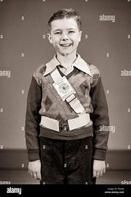 Young boy with crossing guard safety belt from the 1950s