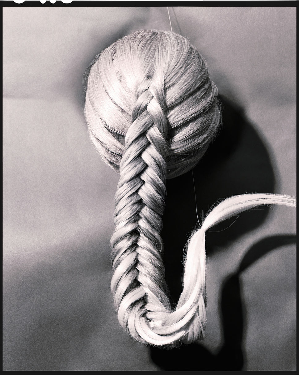 Innovative editorial photograph on large format 4x5 Ilford Delta 100 film, capturing the artistry of a blonde and brown Dutch fishtail braid whimsically caught by a fishing line. Shot through a Sinar large format camera, the image showcases the creative vision of Jesse Jacques at www.jessejacquesphoto.com