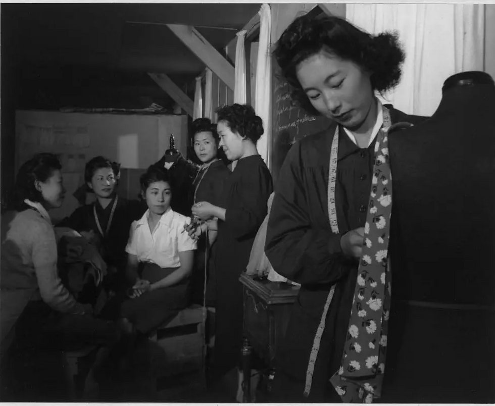 Not only landscapes, but Adams' works also showed the humanity of Japanese Americans living in internment camps in 1943 in the Sierra Nevada Mountains . Here, Ryie Yoshizawa (center) teaches a class on dressmaking.