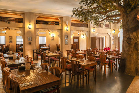 Traditional Emirati dining area at Al Fanar Restaurant with wooden table and vintage decor.