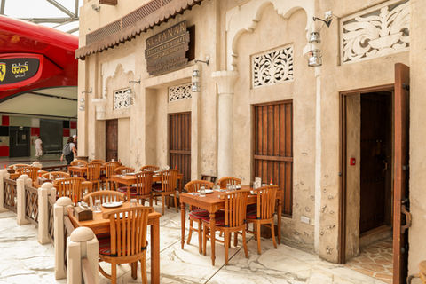 Al Fanar Restaurant outdoor seating area with wooden tables