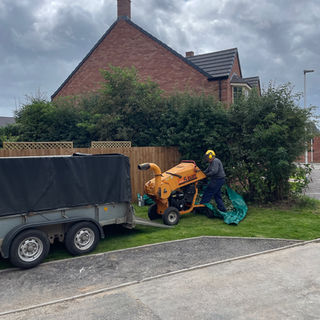 A trailer and chipper clearing a garden