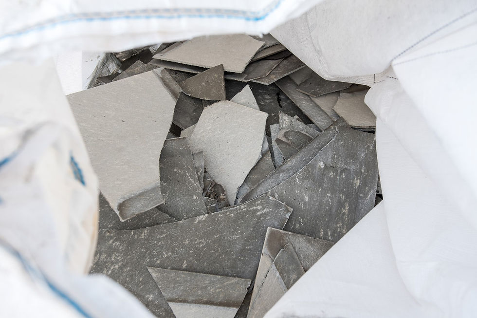 Disposal of damaged asbestos shingles.