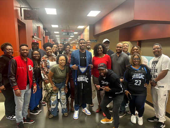 Tiffany Jeffers celebrates LaVell Monger at Osceola Magic game with other community leaders