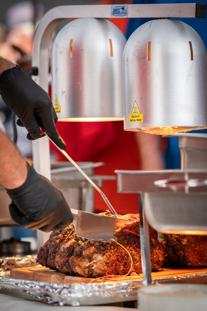 Catering options at Grandpa's Cafe, cutting tender meat under heat lamps.