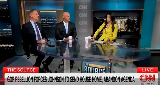 Two male paneliss are interviewed by a female anchor in CNN's studios.