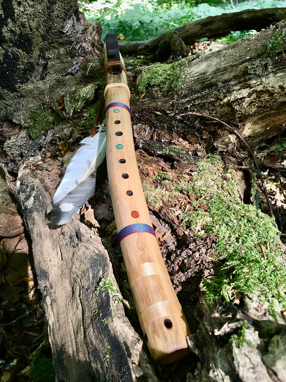 Thumbnail: Handcrafted Native American style flute made of Hazel with a walnut totem and stone inlays in a forest setting.