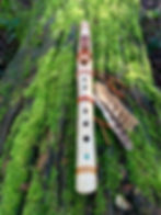 Thumbnail: Handcrafted Native American style flute of Hazel tuned to C 528 Hz on mossy log in forest scene.