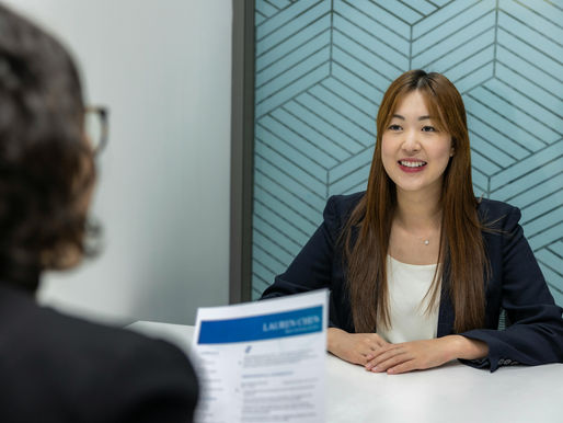 Young woman in a business meeting with an interviewer, showcasing confidence and professionalism.