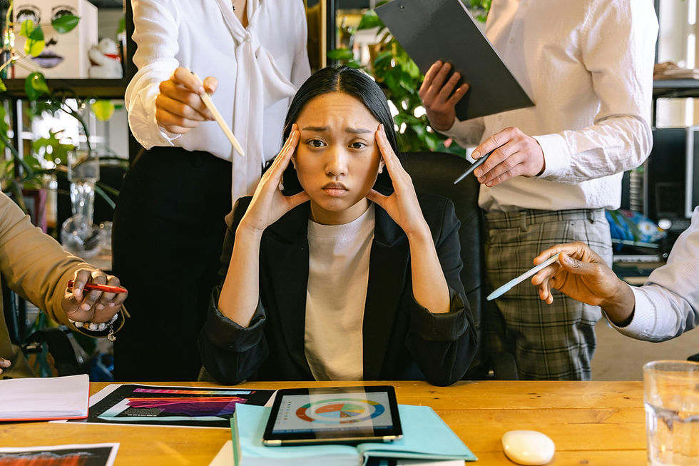 A stressed Virtual Assistant in smart casual attire an office setting.