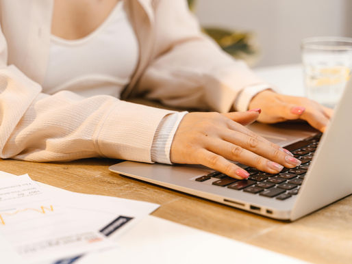 A Virtual Assistant with Manicured Nails Typing on Laptop