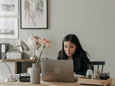Woman in Black Long Sleeve Shirt Using Laptop