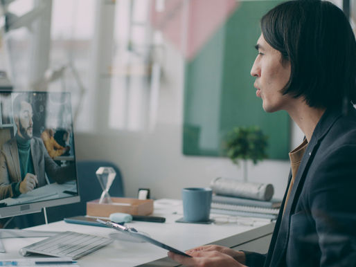 A Virtual Assistant engaged in a video conference in a modern home office setting.