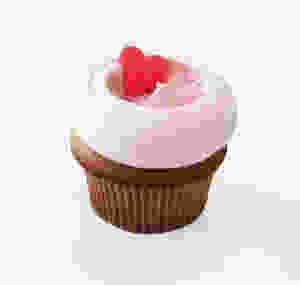 one hot pink heart-shaped candy, on top of light strawberry frosting, on top of an angel food cupcake