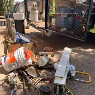 Debris from ground being loaded onto junk removal trailer