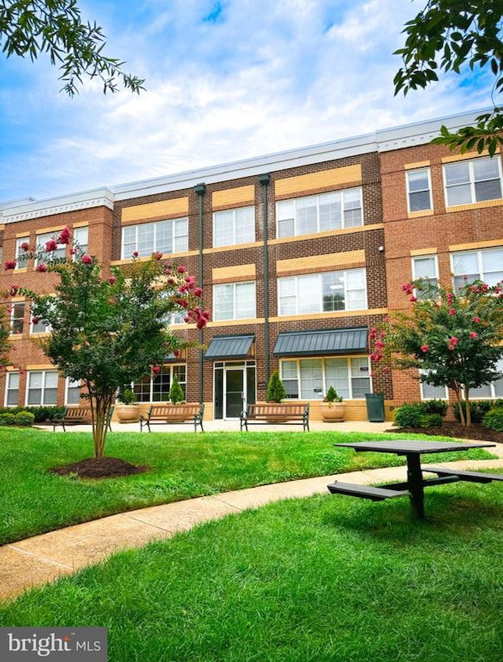 Office building space with green grass and blue skies.