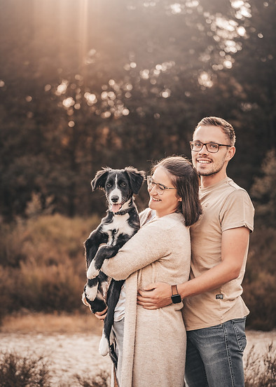 Couple has dog in their arms