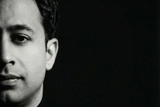 Headshot of Andrea Ahmed with black background