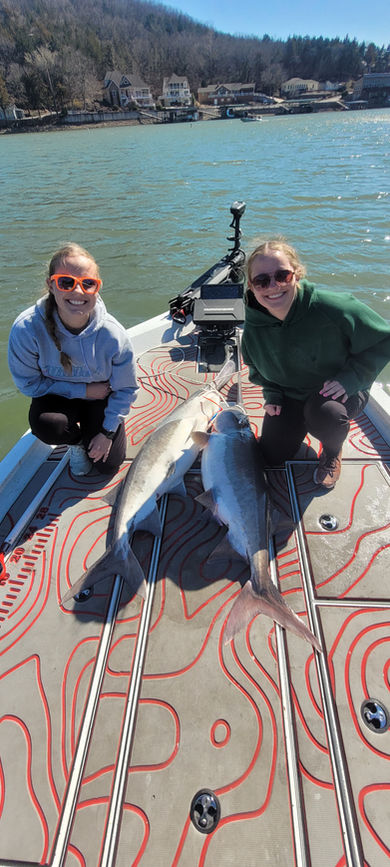 Two women showing off their fish caught on a Lake of the Ozarks fishing charter with Captain Nicholas Ault, also known as Captain Crocs