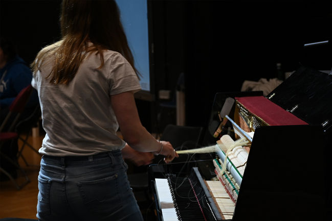 musicians and filmmakers run a workshop in experimental AV. Student listening to teachers. student creating music and art work making films audiovisual