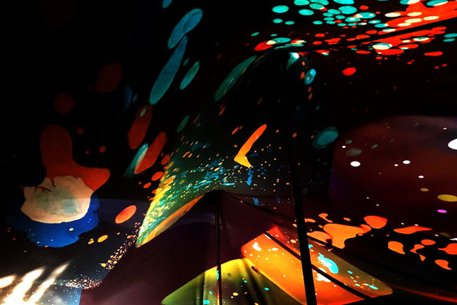 liquid light projections illuminate a marquee at night, a church chapel is decorated with liquid light projections, the yurt cafe becomes a canvas for liquid light shows.