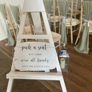 pick a seat not  aside we're all family once the knot is tied white backed acrylic sign.jp