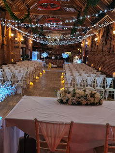 Criss cross fairy lights and ivory chair drapes