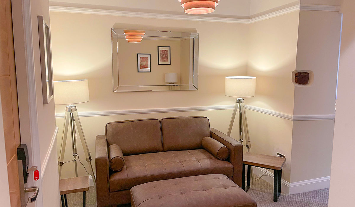 Communal lounge area sofa in Westwood Aparthotel in Glossop