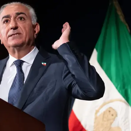 Iran’s exiled crown prince Reza Pahlavi delivers remarks during a Washington news conference, outlining his vision for Iran’s future as an Iranian flag stands behind him.