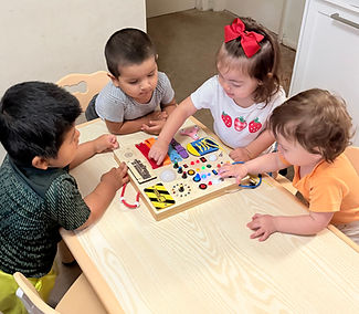 Children participating in a hands-on learning activity together at Bright Hands Academy