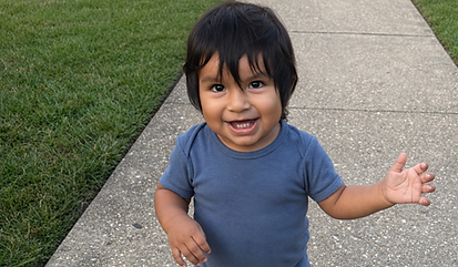 Toddler smiling during outdoor play and gross motor exploration