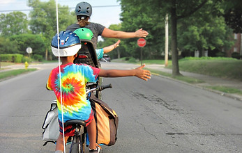 a group of people of different ages and races riding bikes together