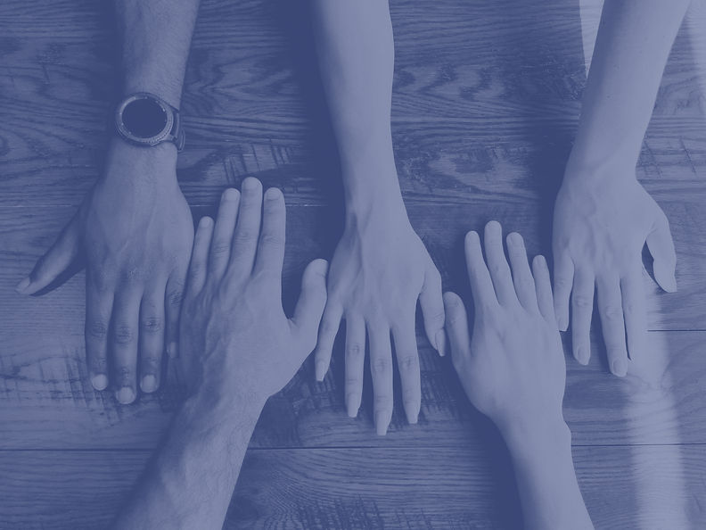 hands of different skin tones lined up