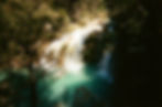 Waterfall flowing into turquoise water in a film gallery
