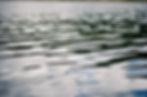 Close-up of gentle ripples on water in a film gallery.