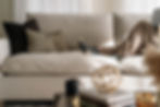 a woman resting on a feather sofa cushion
