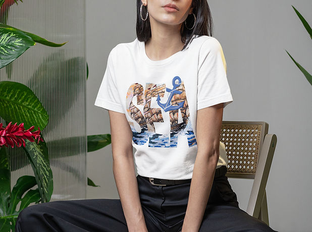 bella-canvas-t-shirt-mockup-featuring-a-woman-sitting-on-a-chair-in-a-room-with-plants-m54