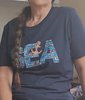 A picture of a women waring a T-shirt from our collection, sanded by a customer