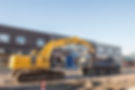 Excavator Loading a Tri-Axle Dump Truck