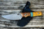 Close-up view of a knife handle made from polished stabilized wood