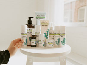 A collection of Hale and Hush skincare products neatly arranged on a wooden stool, showcasing gentle formulas ideal for sensitive skin.