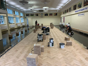 new parquet flooring being laid in a secondary school library. Construction in Education. School renovation