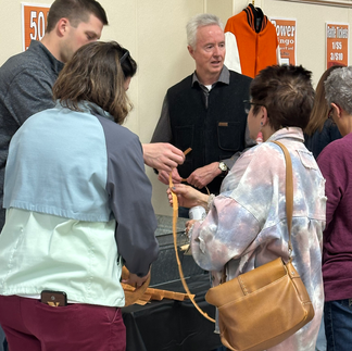 People gathered around table, interacting with each other. Bingo Bash 2025, socializing.