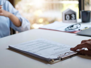 A woman with had on resume about to conduct a job interview - Paula Donnan Advisory