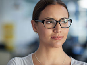 A woman looking to her right thinking about her next career move.