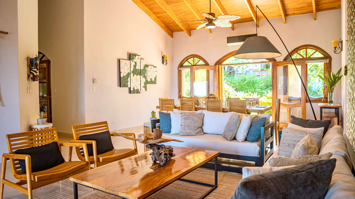 Sunny living room with couches and cathedral wood ceilings