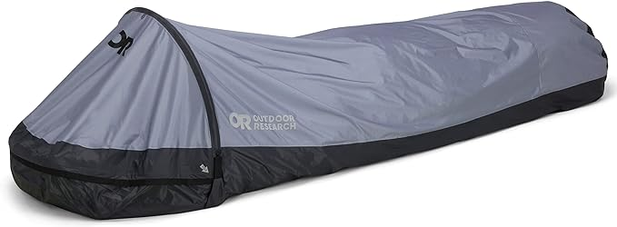 Gray bivy sack with a black base, featuring Outdoor Research logo. It's on a neutral background with no people or additional surroundings.