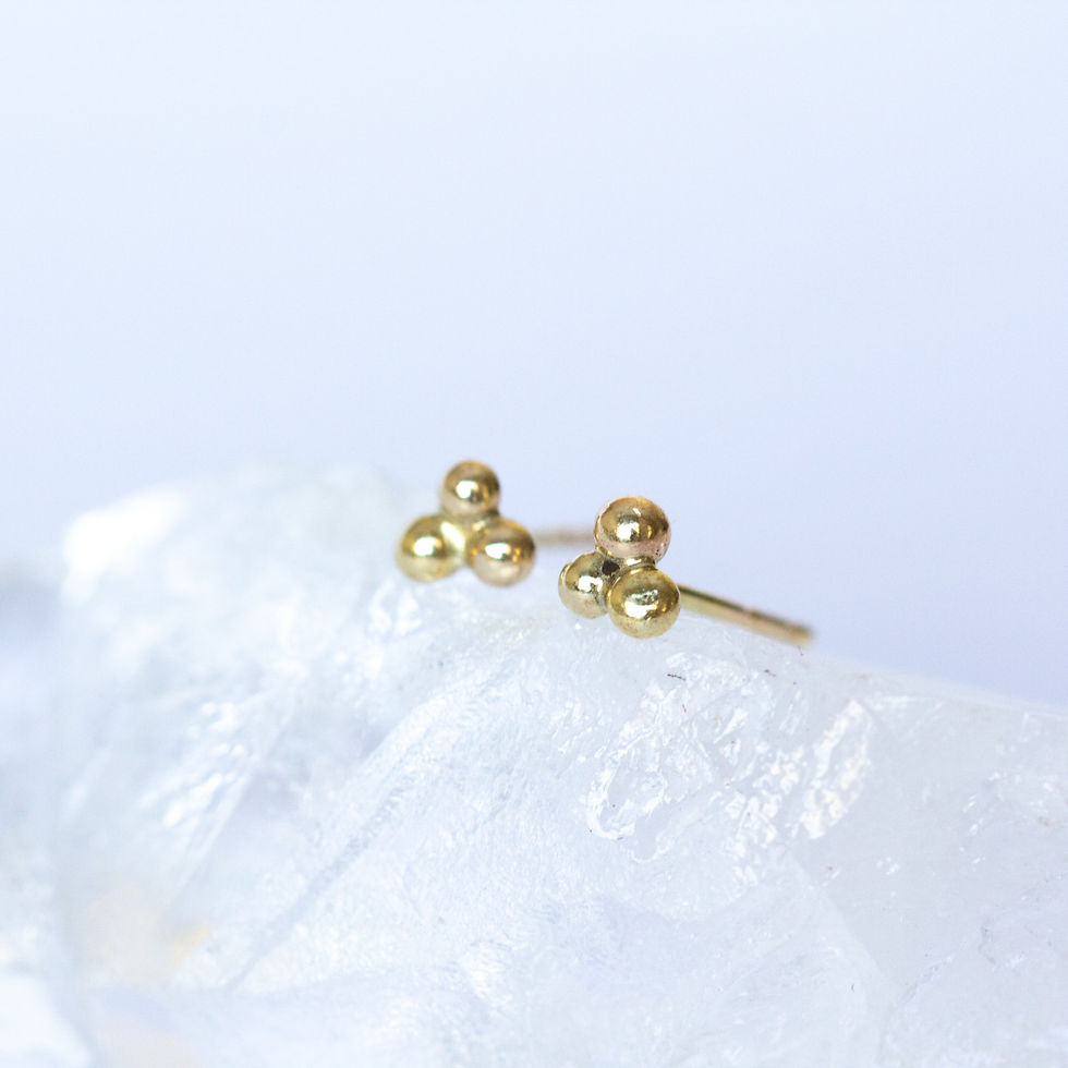 14k Gold clover design stud earrings on crystal and white background unique handcrafted jewelry from Jerusalem